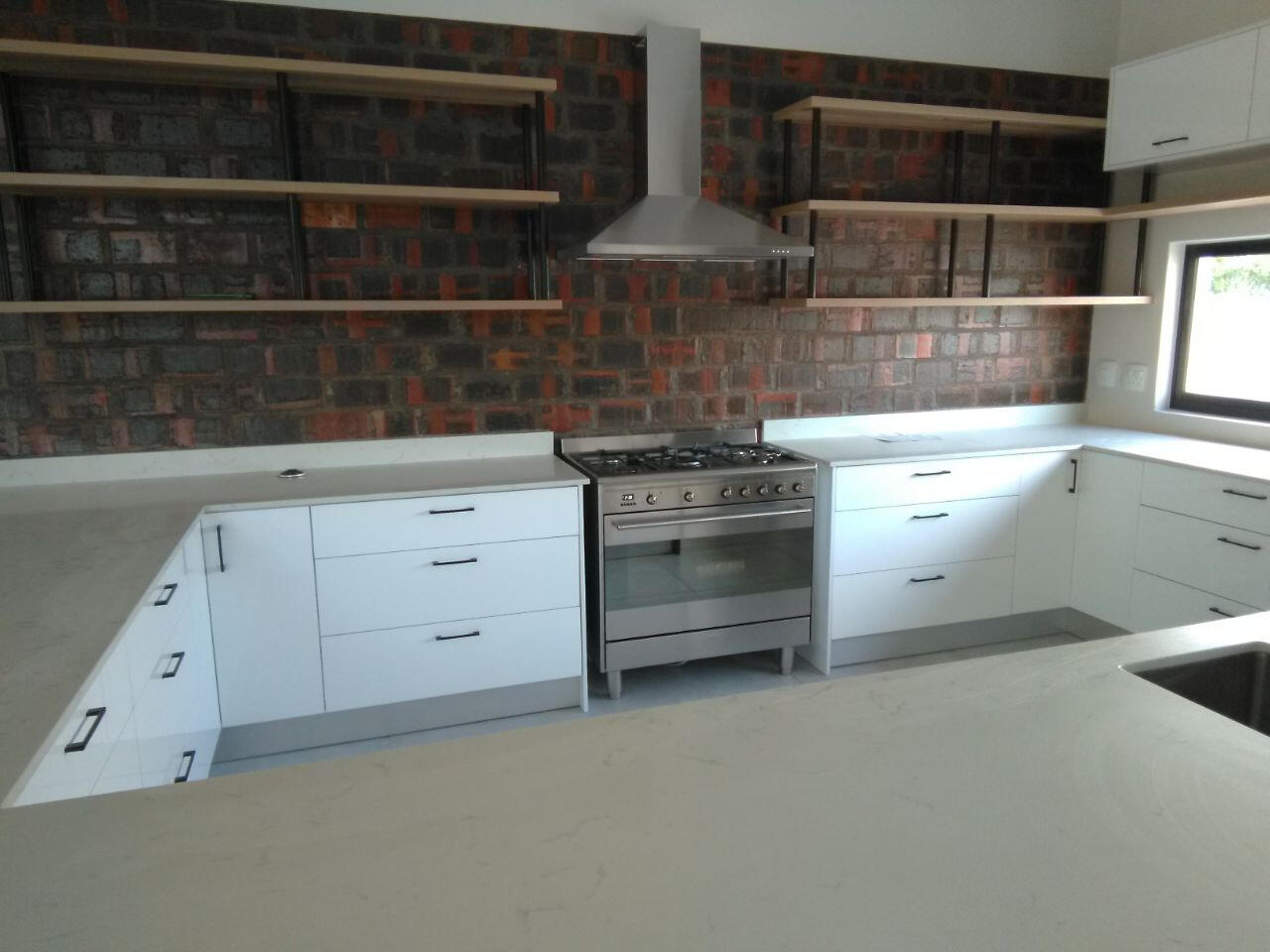 Kitchen Clean lines, open shelves and mainly drawers.