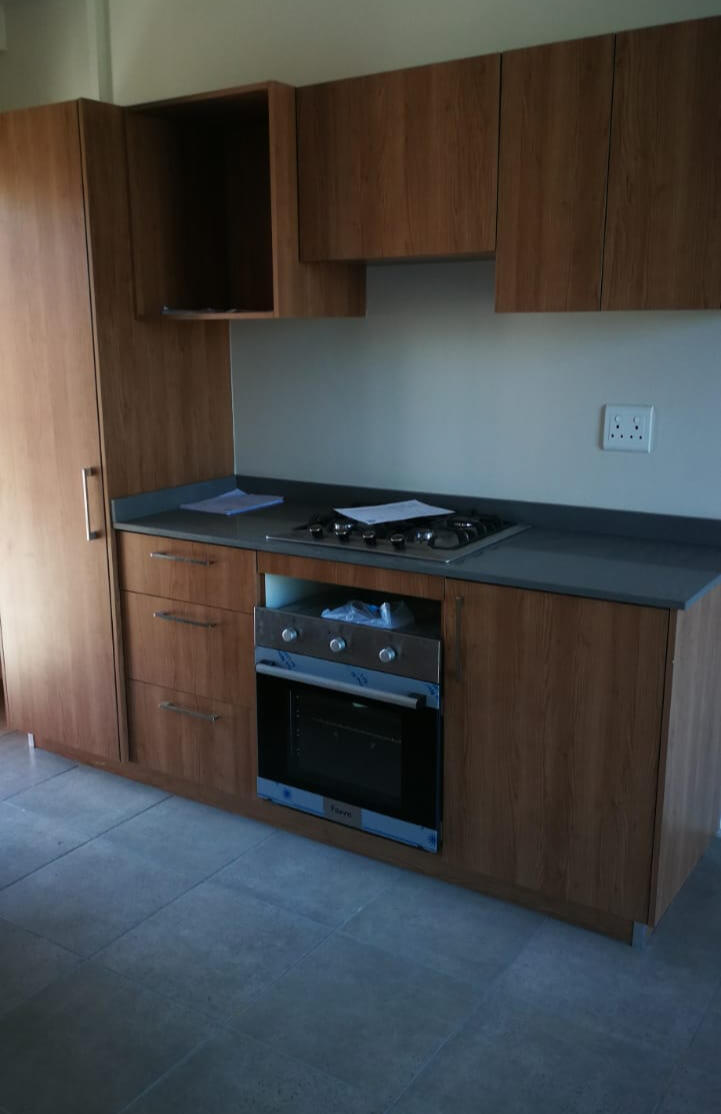 Kitchen A compact kitchen with built in oven and hob.