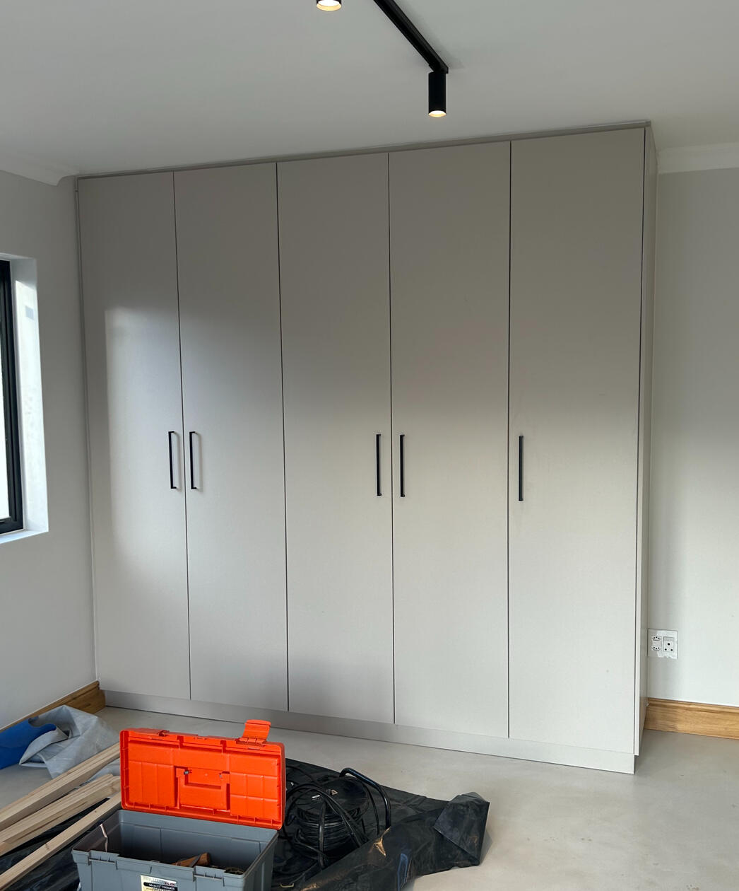 Main Bedroom Cupboards The old cupboards were repurposed and fitted with new doors and handles to modernise the look while staying budget-conscious.