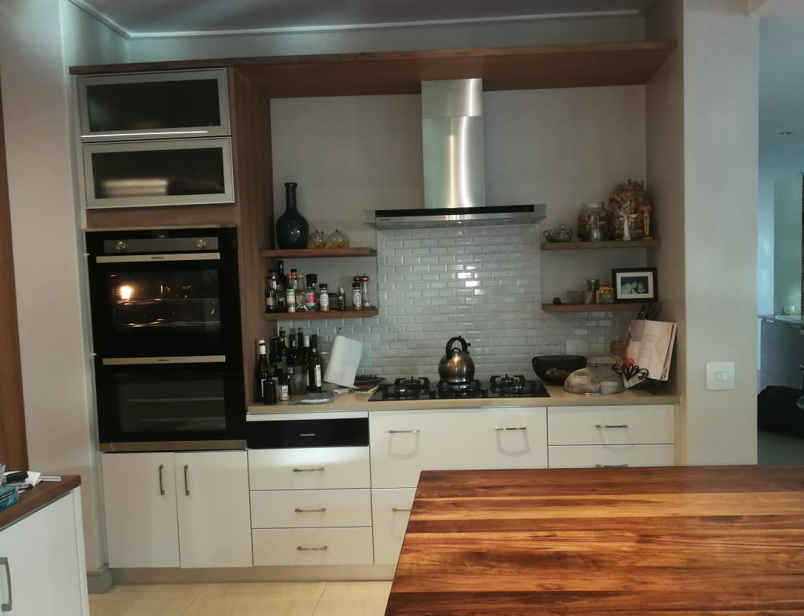 Kitchen cupboards and island Open shelves and lots of drawers helped organise this kitchen around a large wooden top kitchen island.