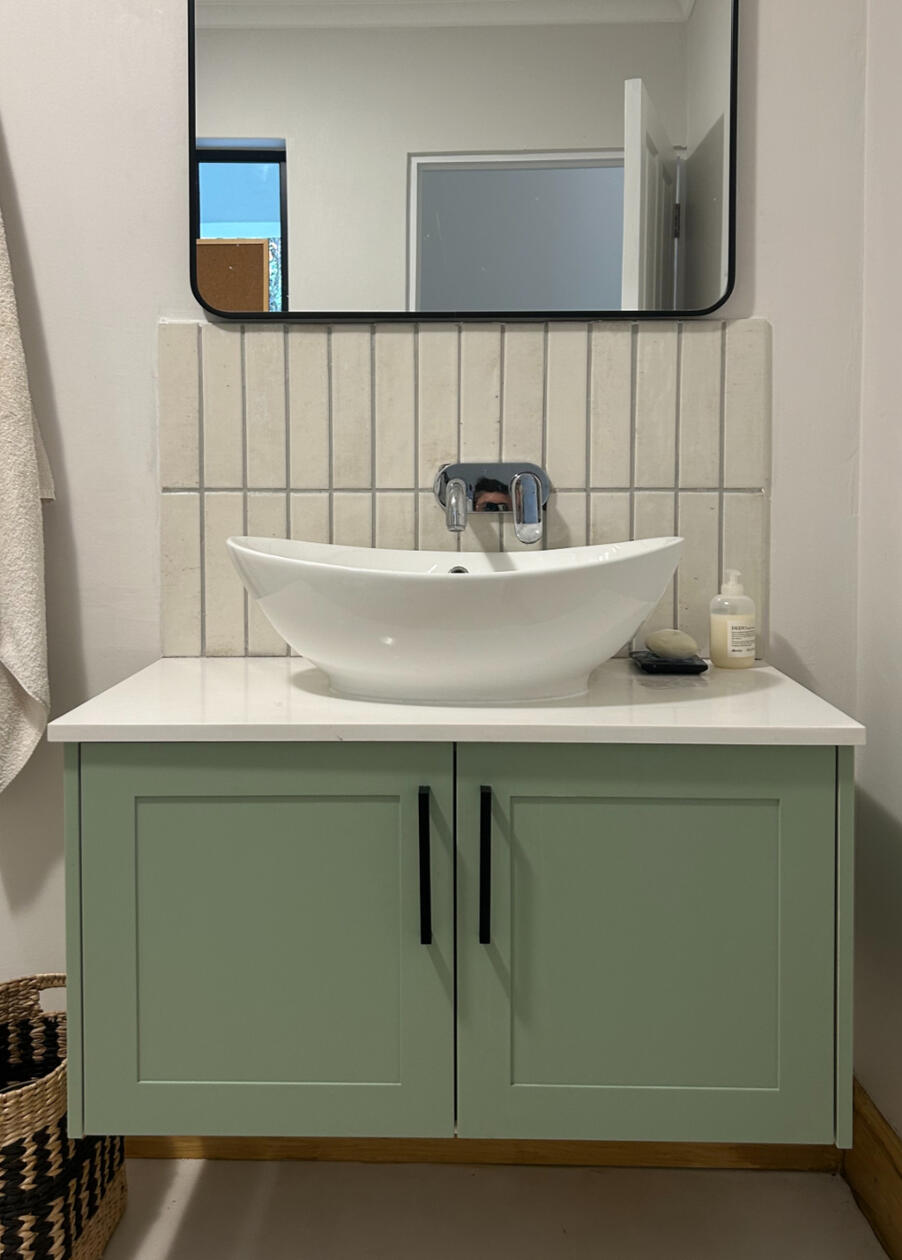 Bathroom Vanity A simple design with shaker-style doors and an engineered quartz top for durability.