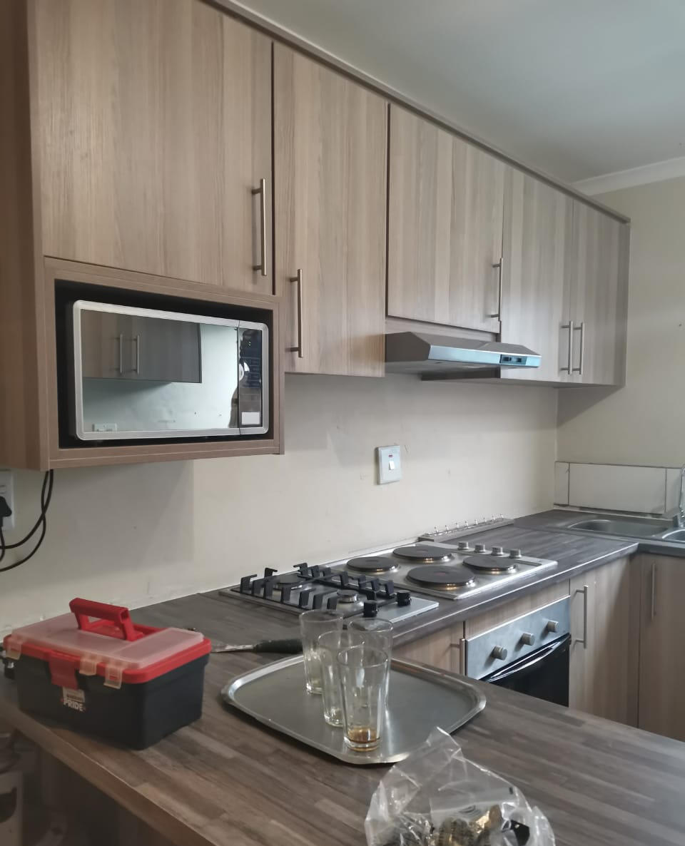 Kitchen A warm wooden look kitchen with a built in microwave